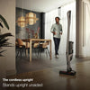 Miele Triflex HX2 Sprinter Cordless Vacuum (Cashmere Grey) - 12206770 – person using cordless vacuum in room