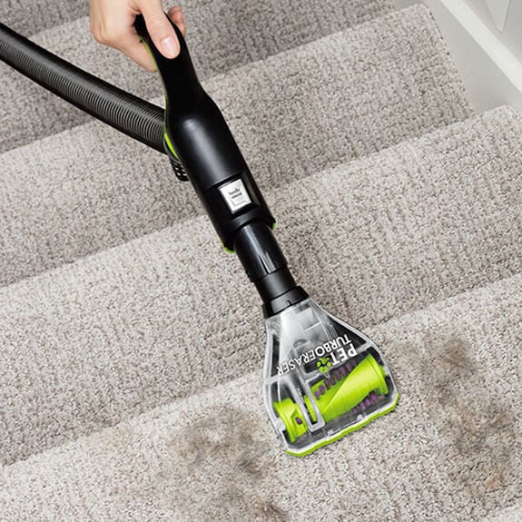 BISSELL Pet TurboEraser Tool 1608089 overhead angled view cleaning a carpeted step