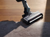 Miele Triflex HX1 Facelift Flash Cordless Vacuum Graphite Grey — illuminated floorhead cleaning beside a rug