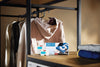 Miele WA CSP 0603 L Sport capsules — capsule packaging beside hanging sportswear