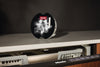Miele GS SETD12 PowerDisk All in 1, set of 12 discs — detergent disc above an open dishwasher
