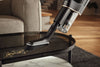 Miele Duoflex HX1 Extra Cordless Vacuum Brilliant White — dusting a table with the handheld brush