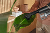 Miele HX-DB Dusting brush with flexible swivel joint — dusting a plant leaf