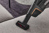Miele HX-EC 10 Compact handheld brush — cleaning upholstery with the compact brush