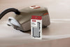 Miele SF-AA 50-1 Active AirClean filter — filter packaging beside a canister vacuum