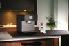 Miele GP DC 102 C Descaling cartridge — cartridge packaging beside a countertop coffee machine