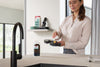 Miele HX-AT 10 Triflex AquaTwister — preparing the cleaning head at a kitchen sink