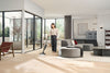 Miele Triflex HX3 Hardfloor Cordless Vacuum Casa Grey — cleaning a living room floor