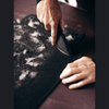 Fang and Fur-Eel PRO Pet Hair Tool Kit 32-1038-06 angled application view removing hair from a vehicle mat