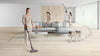 Dyson V15 Detect (Yellow/Iron) Vacuum - 447261-01 – stick vacuum cleaning a living room beside a dog