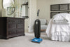 Riccar Cordless SupraLite Lightweight Upright Vacuum-R10CV.10 – blue-base upright in bedroom