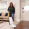 Riccar Deluxe Clean Air Vacuum - R27D – person using upright vacuum in hallway