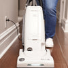 Riccar Deluxe Clean Air Vacuum - R27D – person using upright vacuum in hallway