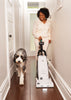 Riccar Clean Air Premium Pet Upright Vacuum - R27P – person using upright vacuum in hallway