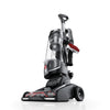 Hoover High Performance Swivel XL Pet Upright Vacuum UH75260V low-angle front three-quarter view showing the dirt cup and onboard tools