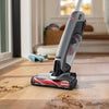 Hoover ONEPWR Evolve Pet Cordless Upright Vacuum Kit BH53422V - angled nozzle view cleaning debris from a wood floor
