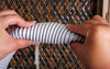 Low Voltage Central Vacuum Hose shown as pliable for easier handling