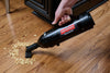 Metrovac Cordless Hand Vac – Part# 105-560098 – black hand vacuum picking up debris from wood floor
