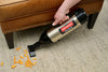 Metrovac Cordless Hand Vac – Part# 105-560098 – silver hand vacuum picking up debris from carpet