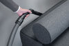 Miele SFD 10 crevice nozzle reaching a narrow gap beside a sofa arm