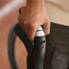 Close-up of a Miele canister vacuum handle held comfortably during use