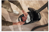 Miele CO HyClean Performance Pack 16 Count w/ HA50 #12909920 – CO bag being fitted in open vacuum compartment