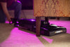 Riccar R25 series upright vacuum shown lying flat to clean beneath furniture. Available at AceVacuums.