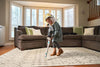 Simplicity Cordless Stick Vacuum – S67 – person vacuuming rug
