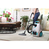 Simplicity Scout Canister Vacuum Cleaner – person using canister vacuum in living room