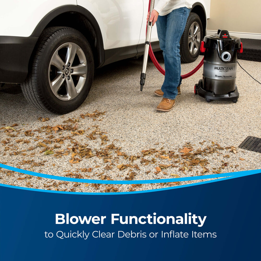 Bissell MultiClean Wet and Dry Auto Vacuum – 2035M – blower clearing leaves from garage