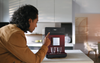 Miele CM 5310 Silence Tayberry Red Coffee Machine #11648140 – person using red coffee machine in a kitchen